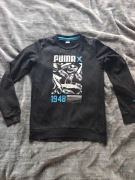 Czarny bluza marki Puma to model Graphics Sneaker Tee rozm YXL