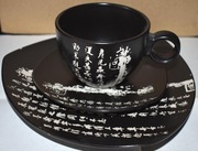 Czarna chińska ceramiczna filiżanka z podstawkami
