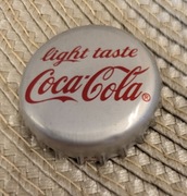 Kapsel Coca-Cola butelkowane