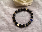 Bransoletka z onyksu, złotymi serduszkami i koralikiem „Oko Proroka”