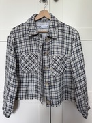 Kurtka Zara w kratę z kieszeniami i kołnierzem.