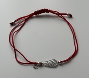 Bransoletka YES na czerwonym sznurku ze skrzydłem