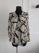 Elegancka beżowa bluzka z długim rękawem w czarne wzory, S/36