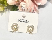 eleganckie kolczyki w formie złotych okręgów z kokardką