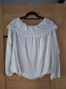 Biała elegancka bluzka z koronką wokół dekoltu