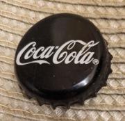 Kapsel Coca-Cola butelkowane