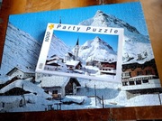 Puzzle 1000 el.   Alpejska wioska zimą  Góry kościół śnieg Komplet