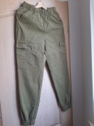 Divided - Dziewczęce spodnie w kolorze zielonym (musztardowym), rozm. 34