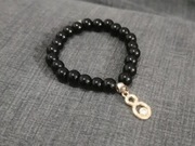 Bransoletka koraliki czarne z ozdobą 