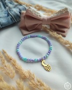 Bransoletka z masy perłowej ze złotą zawieszką pawiem ze stali szlachetnej