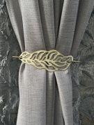 Zestaw czterech metalowych klamr do upinania zasłon i firan