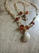 Zestaw bransoletka i naszyjnik z muszlą i bursztynem