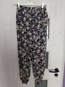 Luźne spodnie damskie motyw kwiatowy przewiewne rozmiar 40