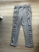 Spodnie z falbanką i brokatową nitką 122/128