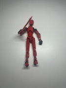 czerwony ludzik z ruchomymi kończynami i mieczem