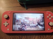 Nintendo switch lite coral pół roczny 