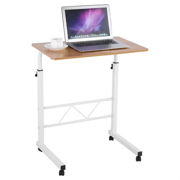 Компьютерный стол с регулируемой высотой, стоящий на столе, с передвижным диваном рядом с кроватью.