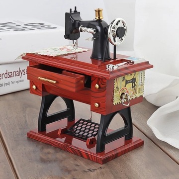 Mechaniczna pozytywka w kształcie maszyny do szycia