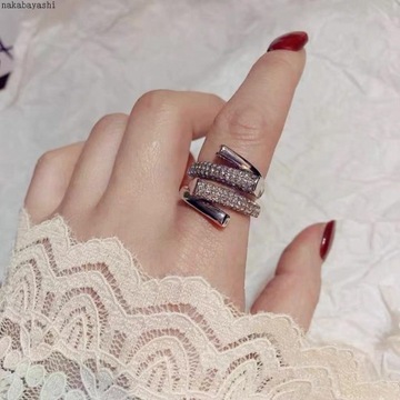Eleganckie otwarte aplowane srebrne pierścionki z