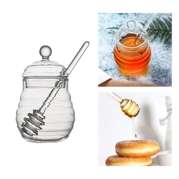 Прозрачный контейнер для меда с ложкой и крышкой.