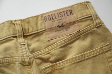 HOLLISTER musztardowe dżinsy z dziurą W 32 L 30