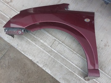 BLATNÍK LEVÝ PŘEDNÍ OPEL MERIVA A 03-05R ČERVENÝ