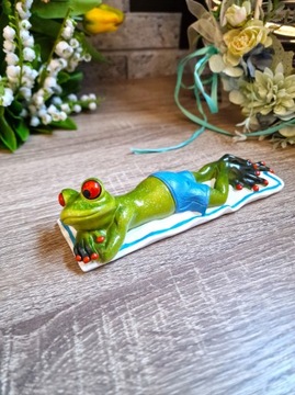 ФИГУРКА ЛЯГУШКИ, ЛЕЖАЩЕЙ НА ПОЛОТЕНЦЕ