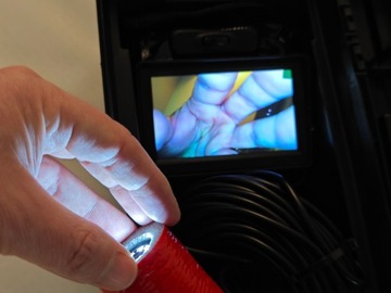 Камера, прикрепленная к Turbospiner Lance для проверки при чистке дымохода.