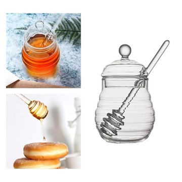Прозрачный контейнер для меда с ложкой и крышкой.