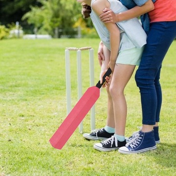 Ребенок в крикет тренируется на открытом воздухе и играет в бейсбол в красном цвете.