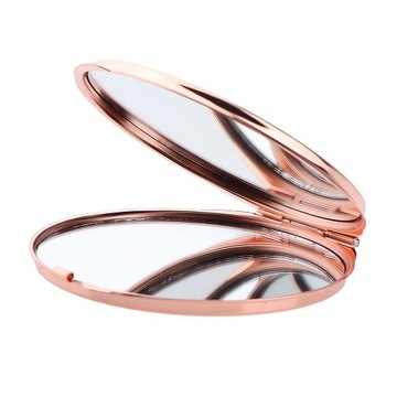 Небольшое портативное круглое косметическое зеркало из розового золота.