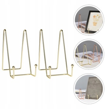 На столе стоит книга, металлический мольберт.