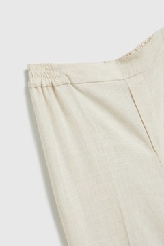 Lniane spodnie z szerokimi nogawkami beżowe XS od MOODO
