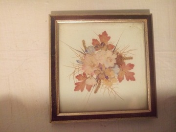Obraz kompozycja kwiatowa za szklem