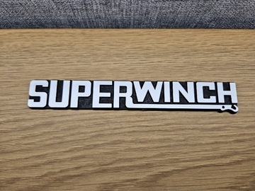 Emblemat Superwinch Nowy