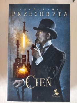 Cień , III tom Materia Prima, Adam Przechrzta