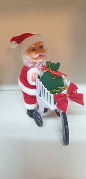Mikołaj z wózkiem zakupowym świeci, gra, chodzi