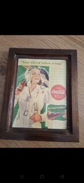 Reklama CocaCola w drewnianej ramce .