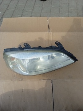 90520878 RH Reflektor Prawy Opel Astra G II HELLA