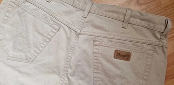 Beżowe spodnie męskie jeans Wrangler Texas W38L34