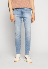 Jeansy slim taper Calvin Klein Jeans 32/34