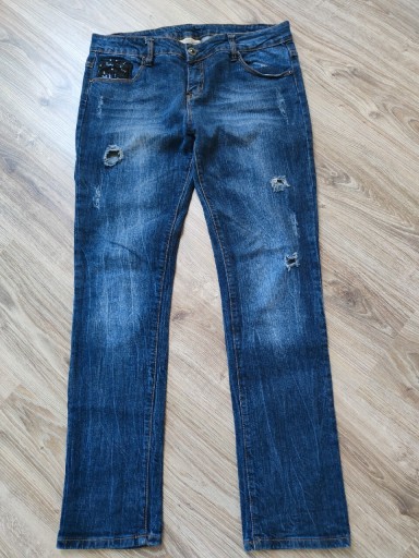 Zdjęcie oferty: Spodnie jeansowe z dziurami 