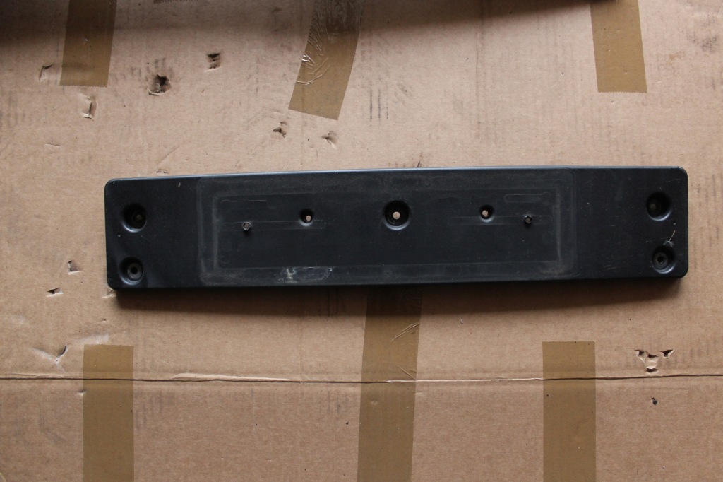 фото №1, Kia rio iii lift основание кронштейн номерного знака перед 86519-1w700 рамка